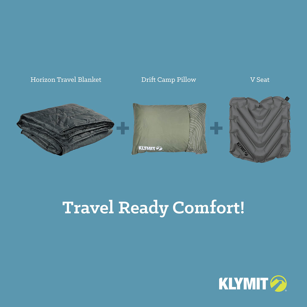 Klymit Horizon Travel Blanket deployed at a campground setup for warmth