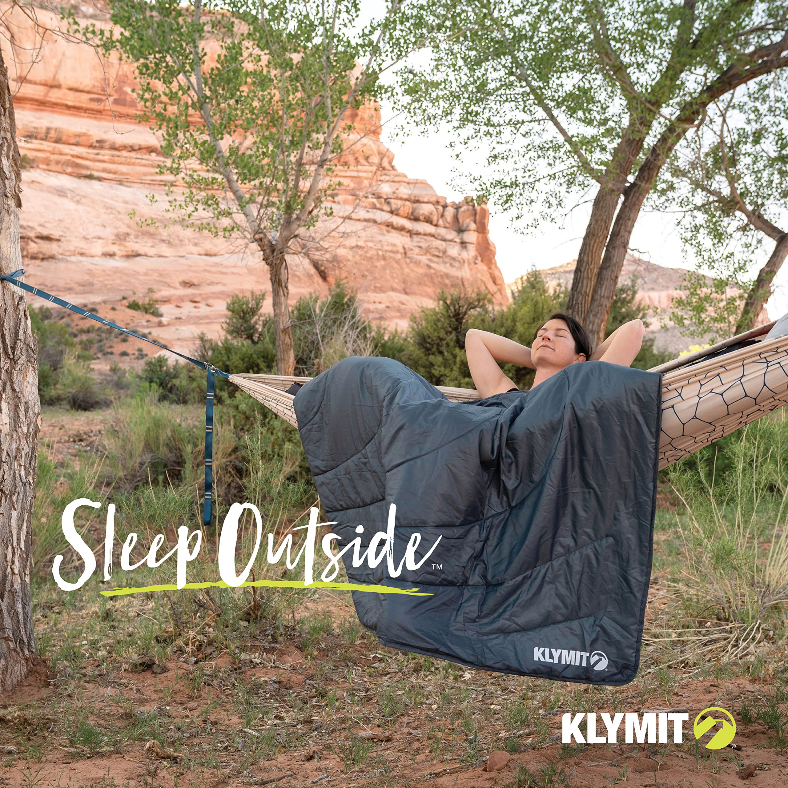 Klymit Horizon Travel Blanket at a stadium outing with secure ground setup