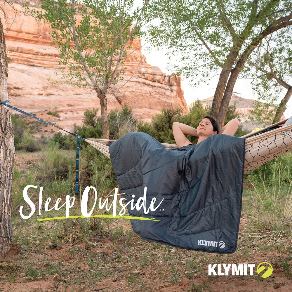 Klymit Horizon Travel Blanket at a stadium outing with secure ground setup