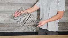 Crab trap ready to cast with a fishing pole