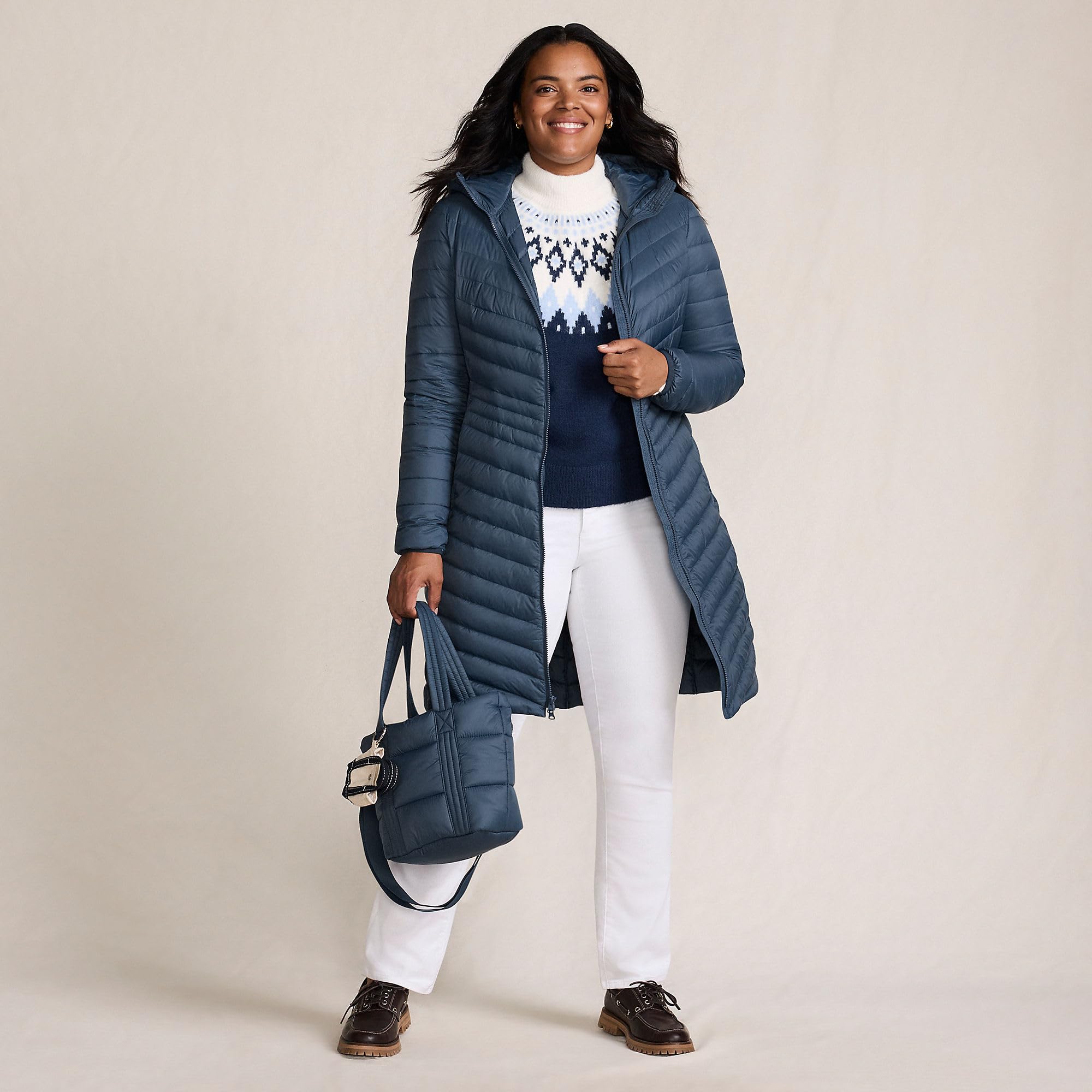 Lands' End packable chevron wanderweight coat packed in bag for easy travel storage.