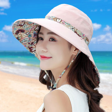 Woman wearing LassZone sun hat at a sunny beach