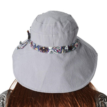 Reversible LassZone sun hat showing solid exterior and floral interior