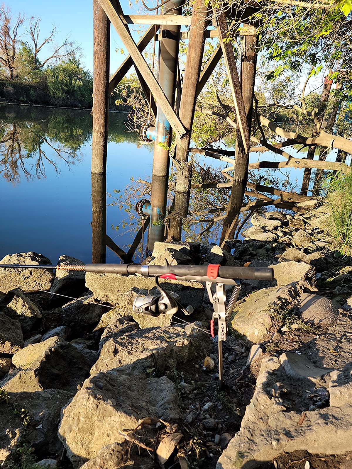 Rod holder installed on muddy bank for ground fishing