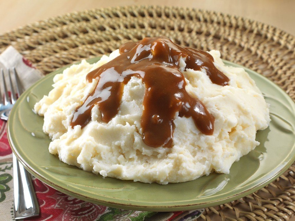 Legacy Premium Essentials mashed potatoes being prepared with boiling water for a quick meal.