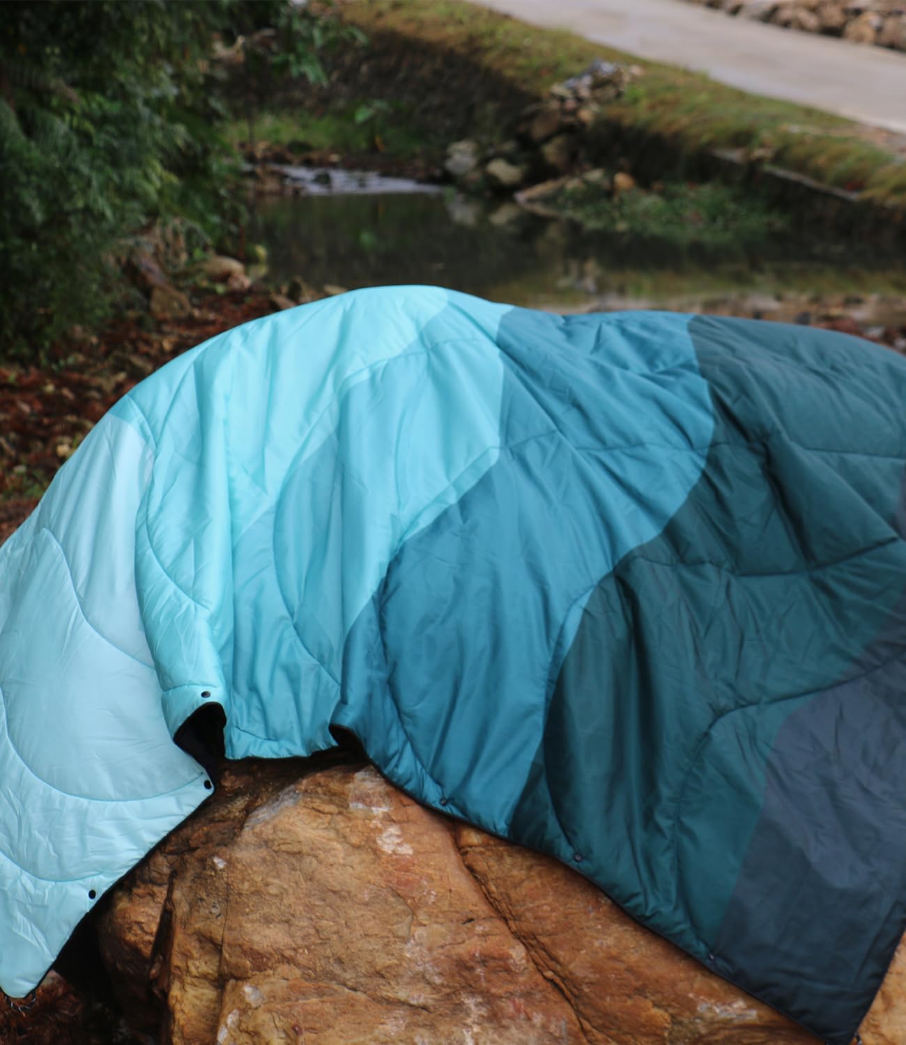 LH Outdoor Puffy Blanket usable indoors for cozy home lounging.