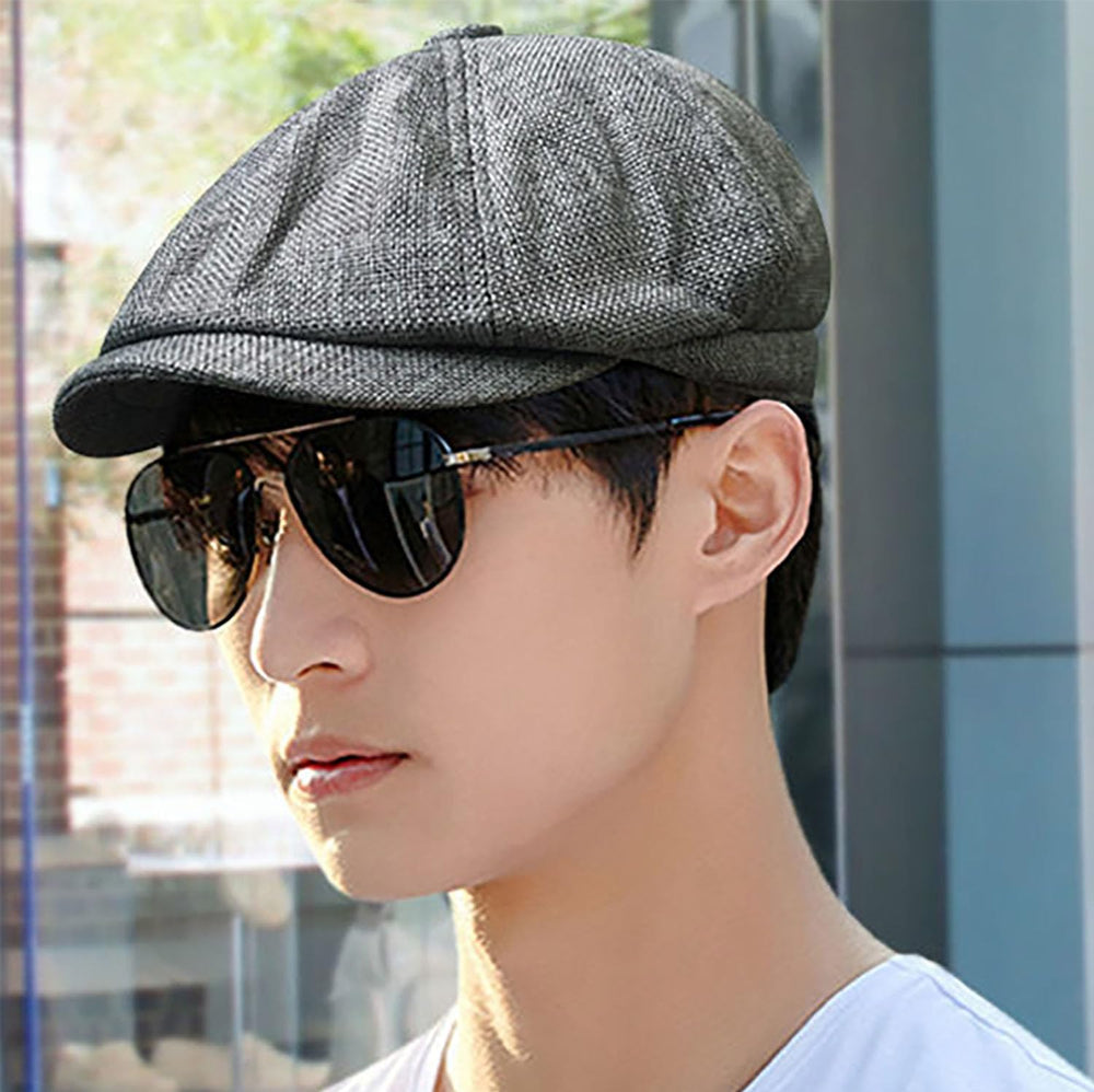 Flat lay of linen men's newsboy cap in dark gray