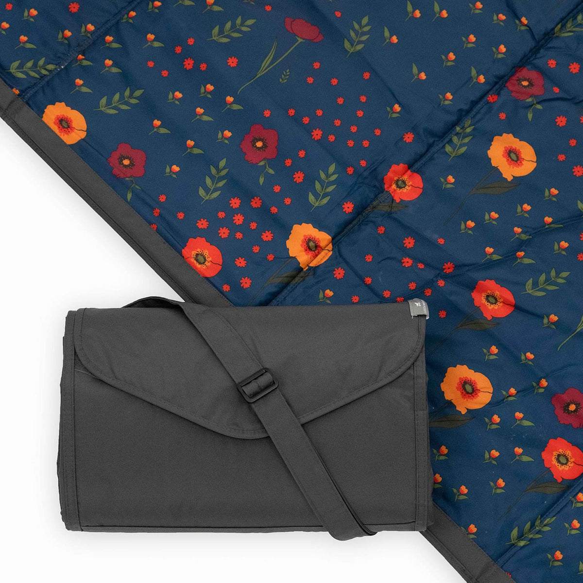 Little Unicorn picnic blanket midnight poppy folded for easy transport and storage.