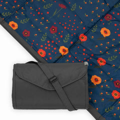 Little Unicorn picnic blanket midnight poppy folded for easy transport and storage.