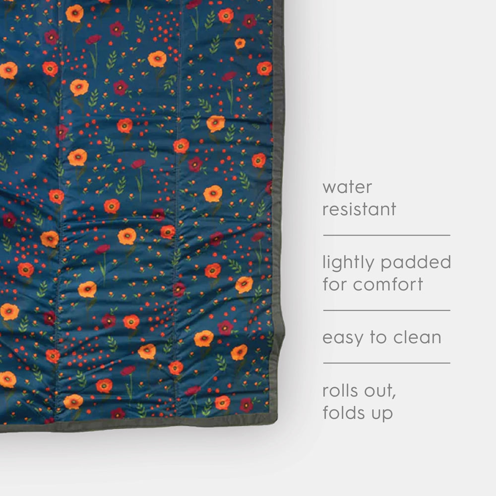 Little Unicorn water-resistant blanket resists damp grassy spots.