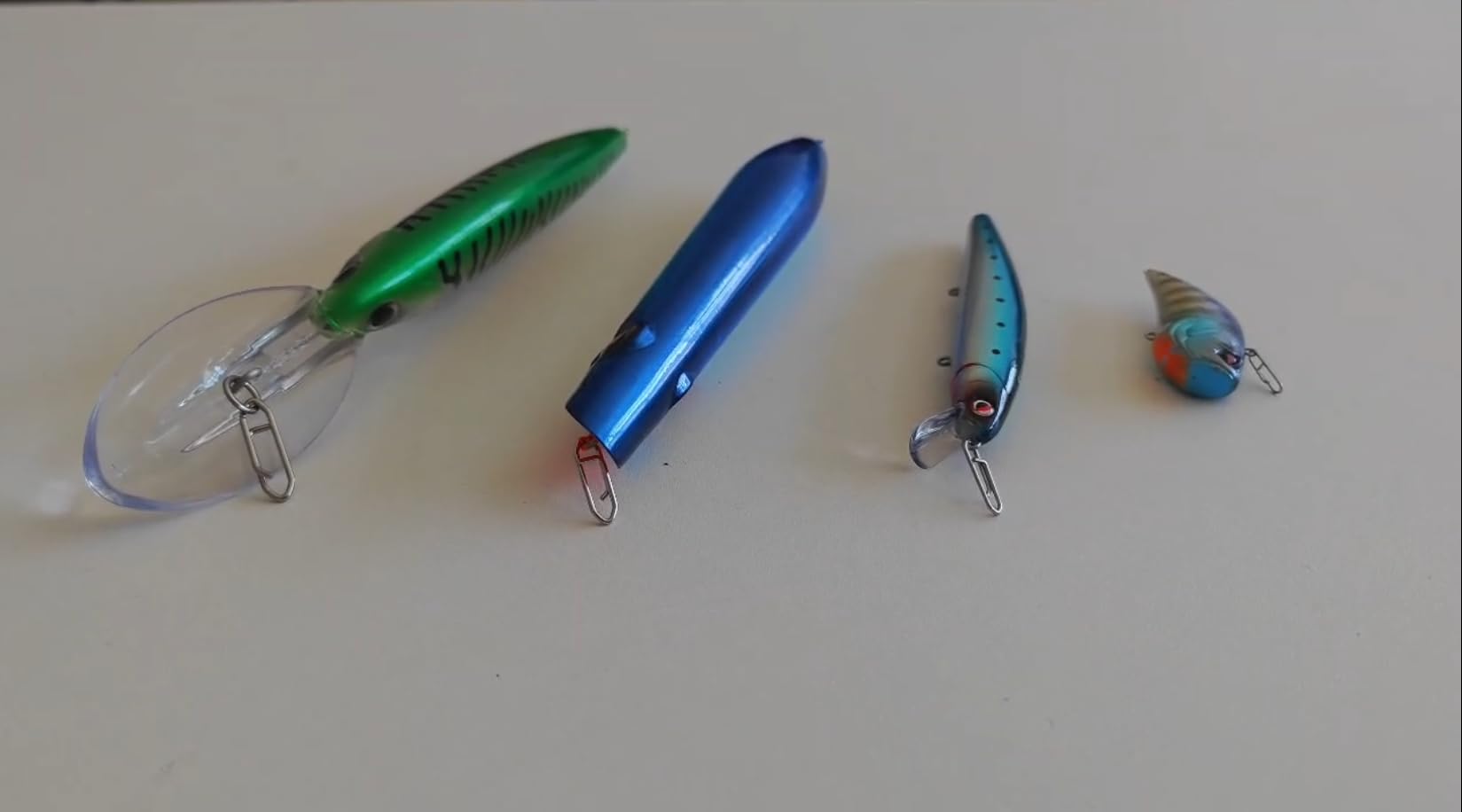Four sizes of LITTMA fishing clips for bass, catfish, salmon and more