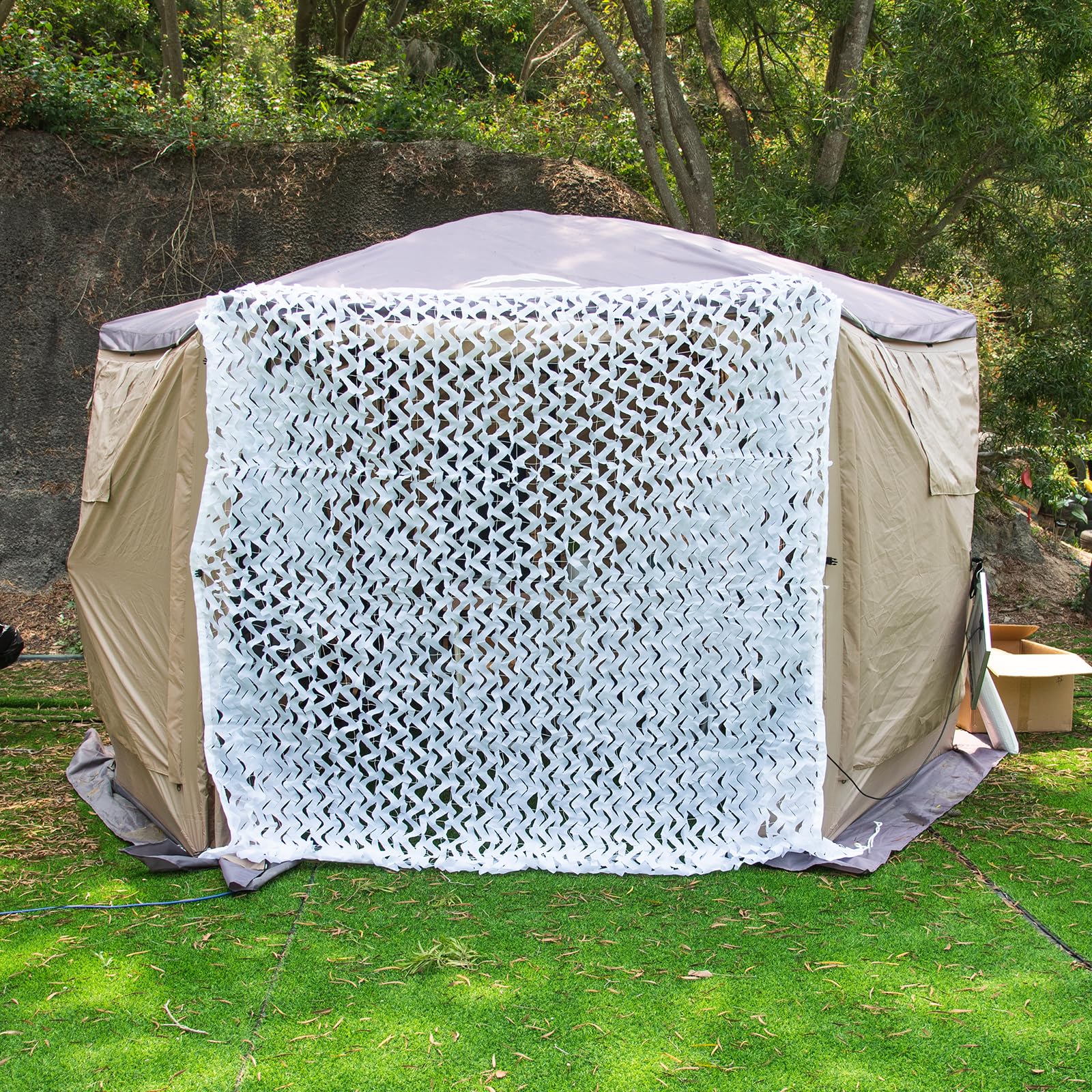 LOOGU camo netting draped over a tree house for realistic concealment