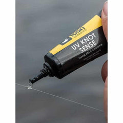 Loon UV Knot Sense applying coating to a knot for smoother passage through guides.