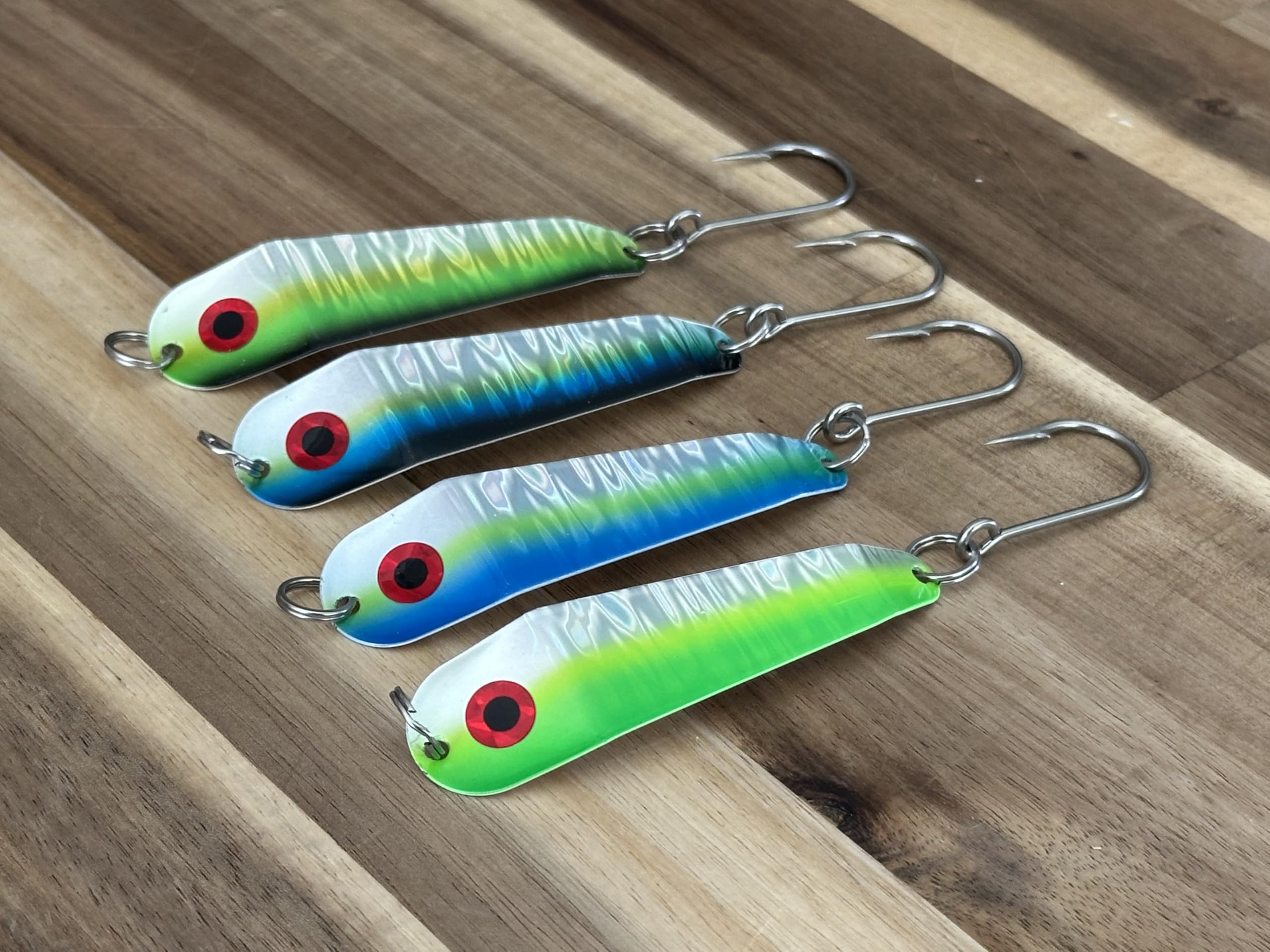 Close-up of Herring Aid, Green Hornet, Blue Dorado and Lemon Lime finishes with UV halo-prism foils.