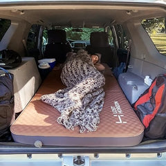 Lost Horizon self-inflating mattress shown from the side for balanced support outdoors.