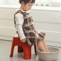 Lovskoo plastic mini stool side view highlights compact profile for easy storage.