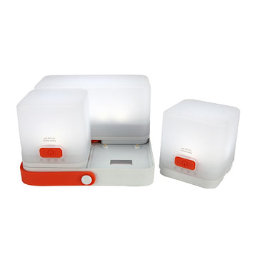 luminaid trio solar cube lanterns docked for versatile outdoor lighting.