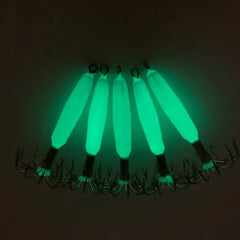 Luminous squid jig hooks close-up highlighting sharp needles for strong hookups.