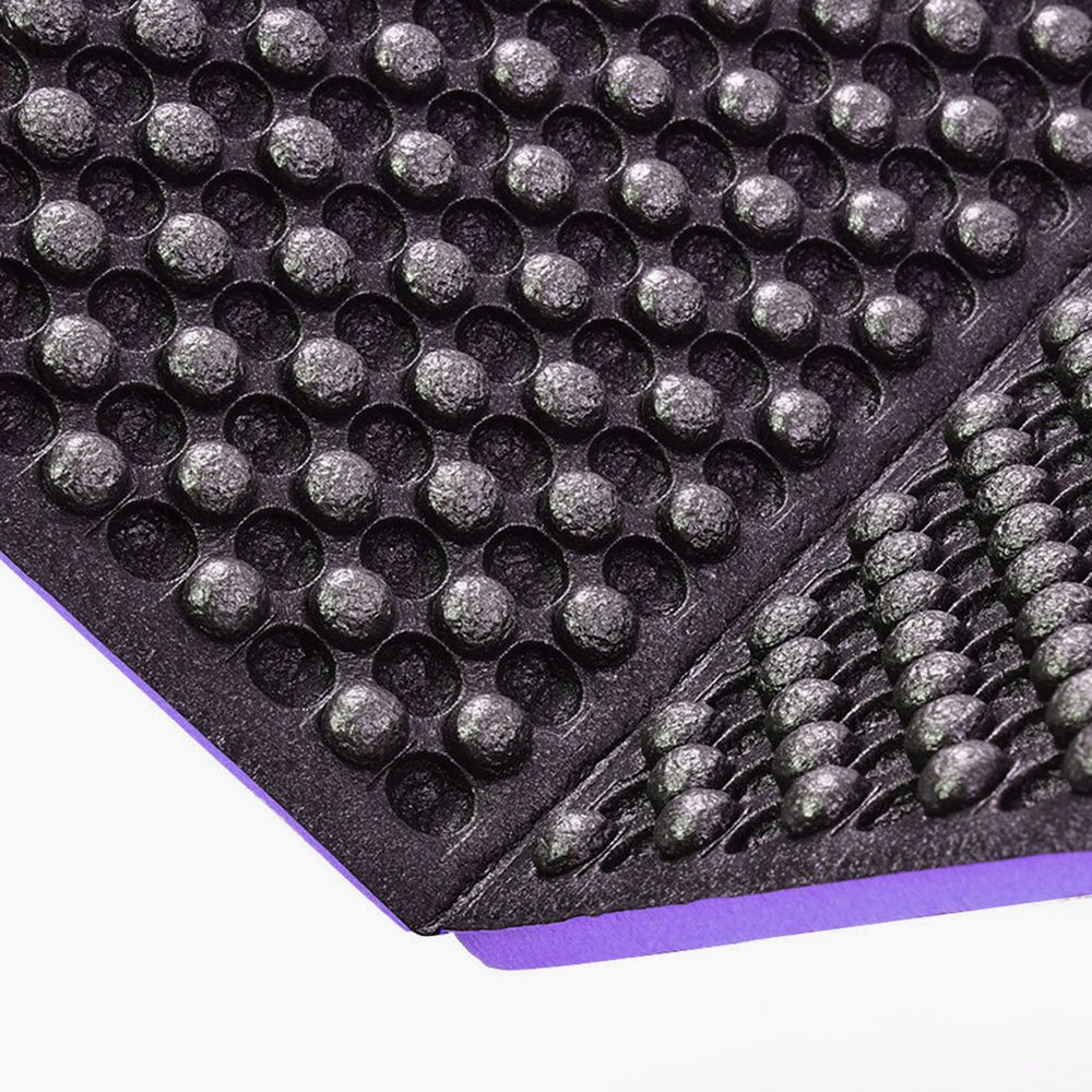 Luqeeg pad used for outdoor yoga on grass, offering gentle cushioning.