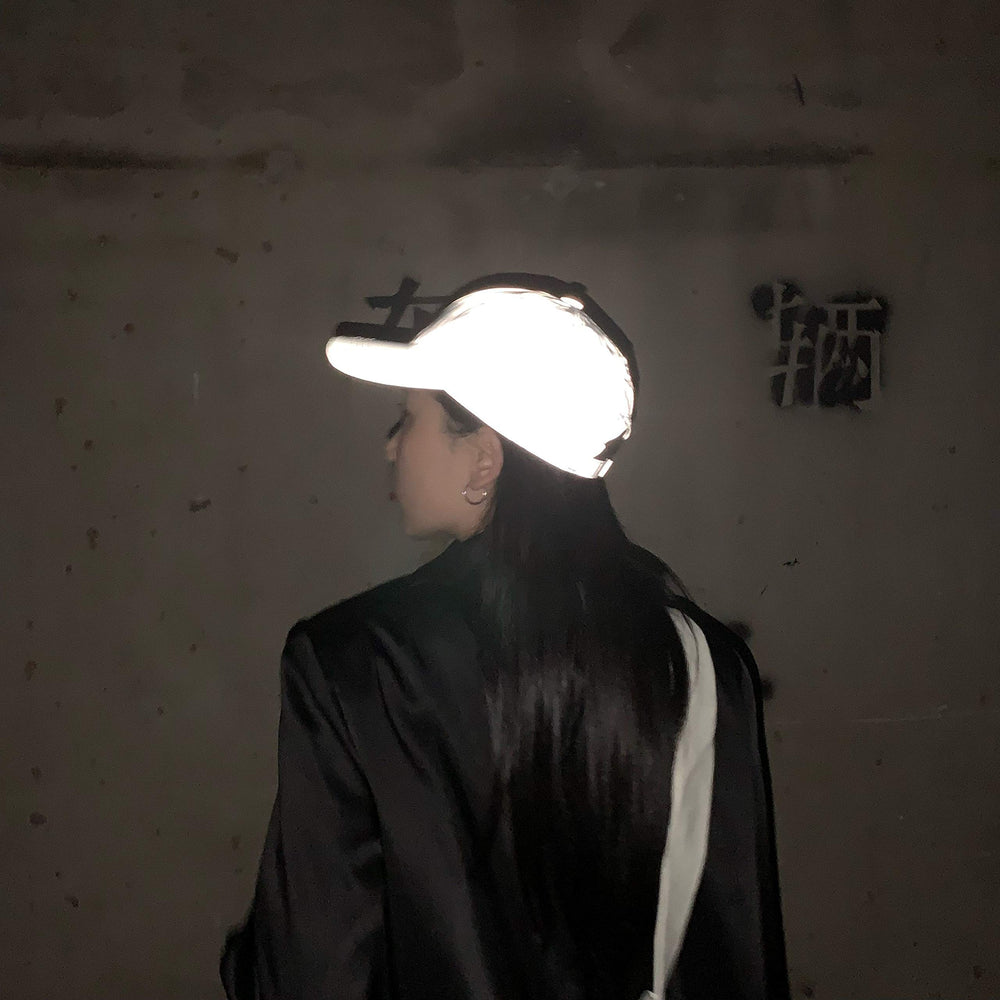 Unisex design LZLRUN reflective hat worn by a person