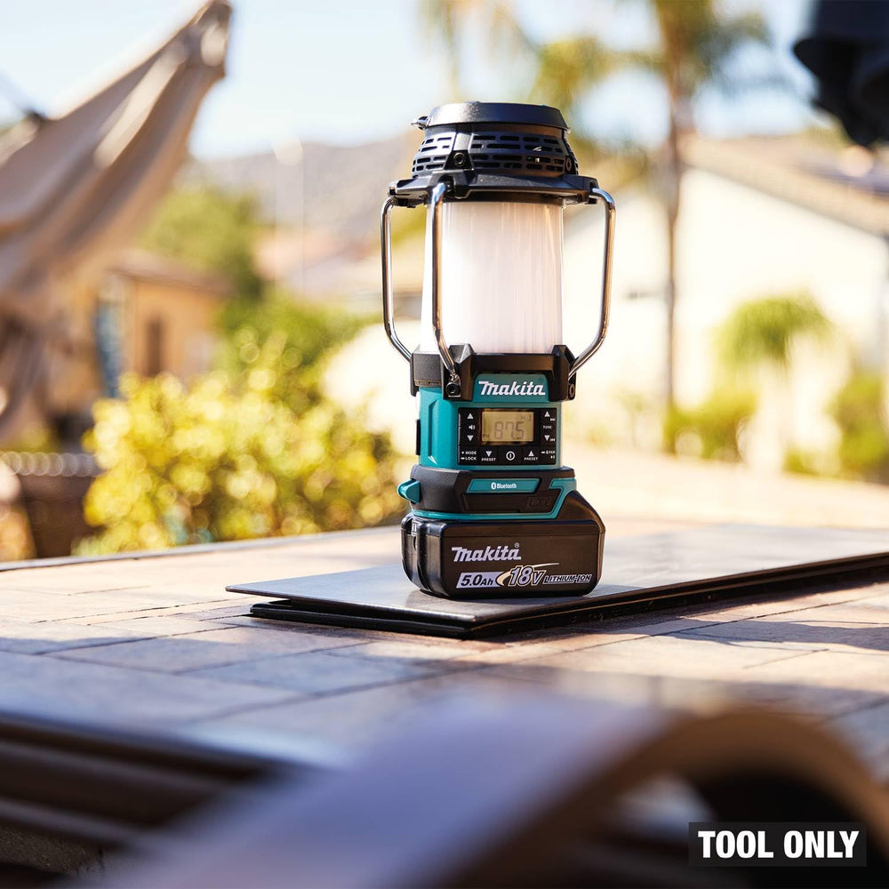 Makita XRM13 USB port charges phones on site.
