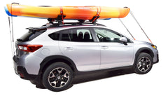 Malone SeaWing with bow and stern tie-downs securing kayak for highway transport.