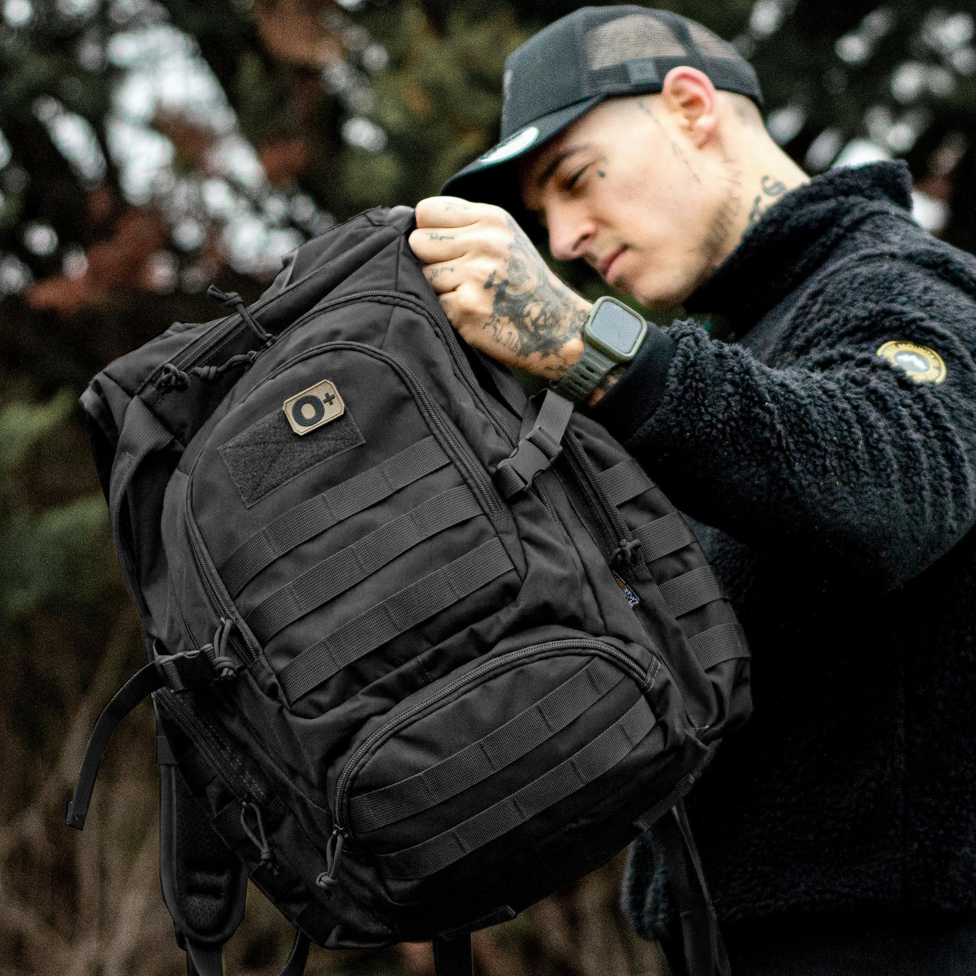 Mardingtop 25L tactical backpack hydration compartment with tube routing from shoulder strap.