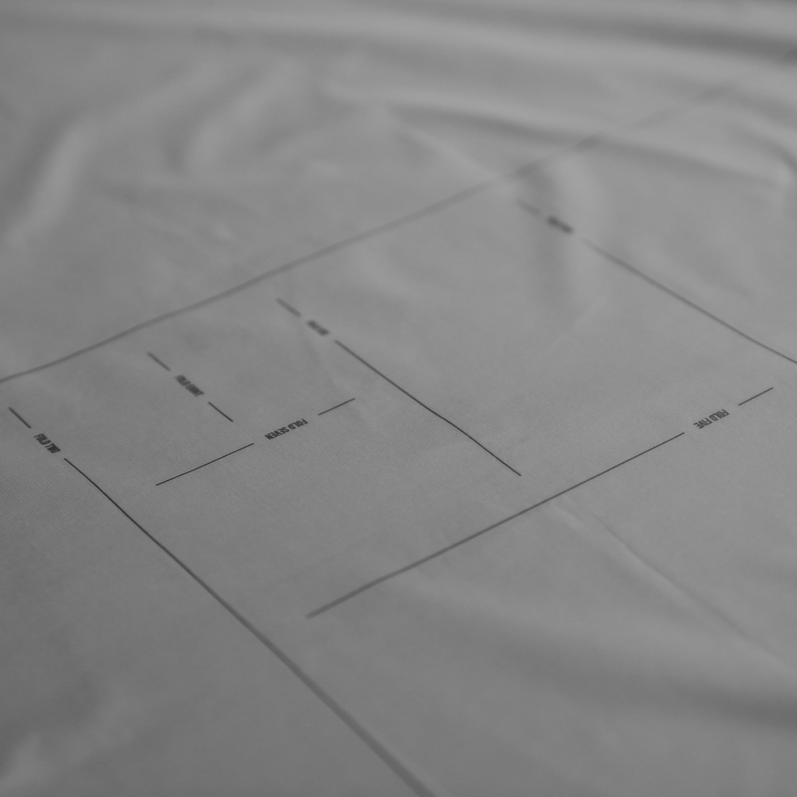 Matador Pocket Blanket 4.0 white tucked into its storage pouch after use.