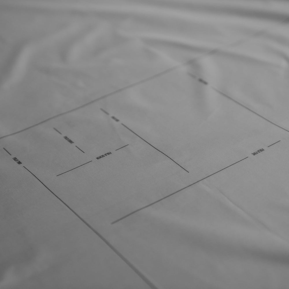 Matador Pocket Blanket 4.0 white tucked into its storage pouch after use.