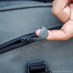 Close-up of small gray zipper pull for tactical gear