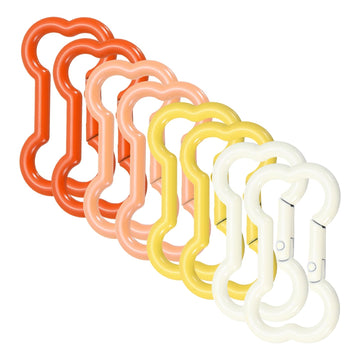 Meccanixity bone-shaped buckle clip in cream white securely attaches keys to a backpack.