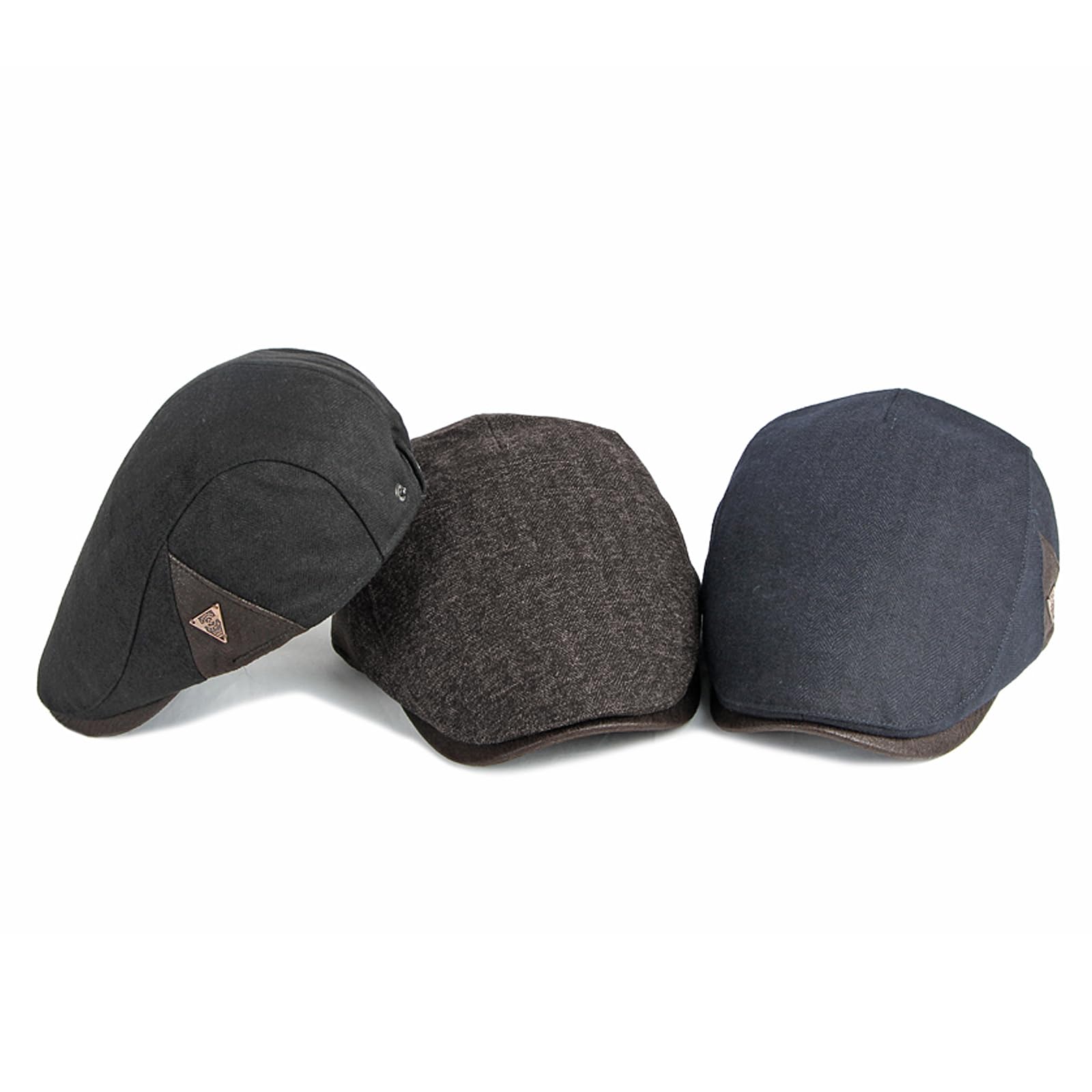 Close-up of fabric texture and stitching on the black newsboy hat