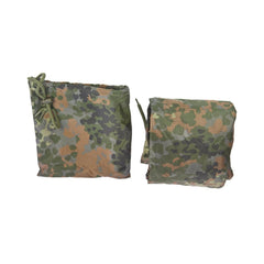 Mil-Tec ripstop poncho used as tarp for gear protection or temporary shelter.