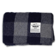 Minus33 Camp Throw Blanket in gray-blue plaid enhances picnics on cool evenings.