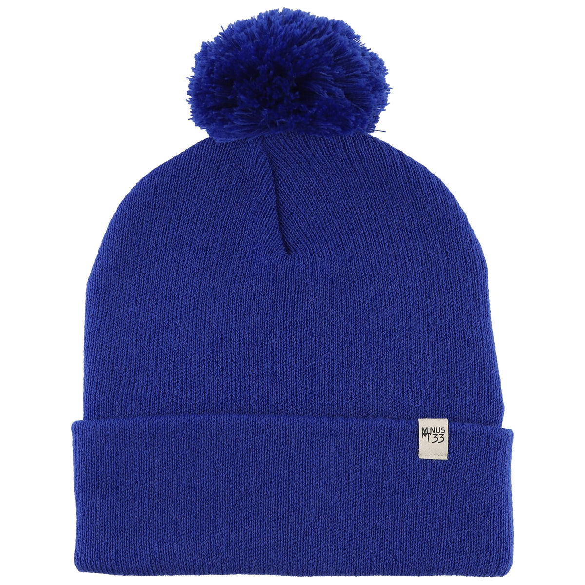 Minus33 Merino midweight pom beanie in royal blue viewed from the front, cozy warmth.