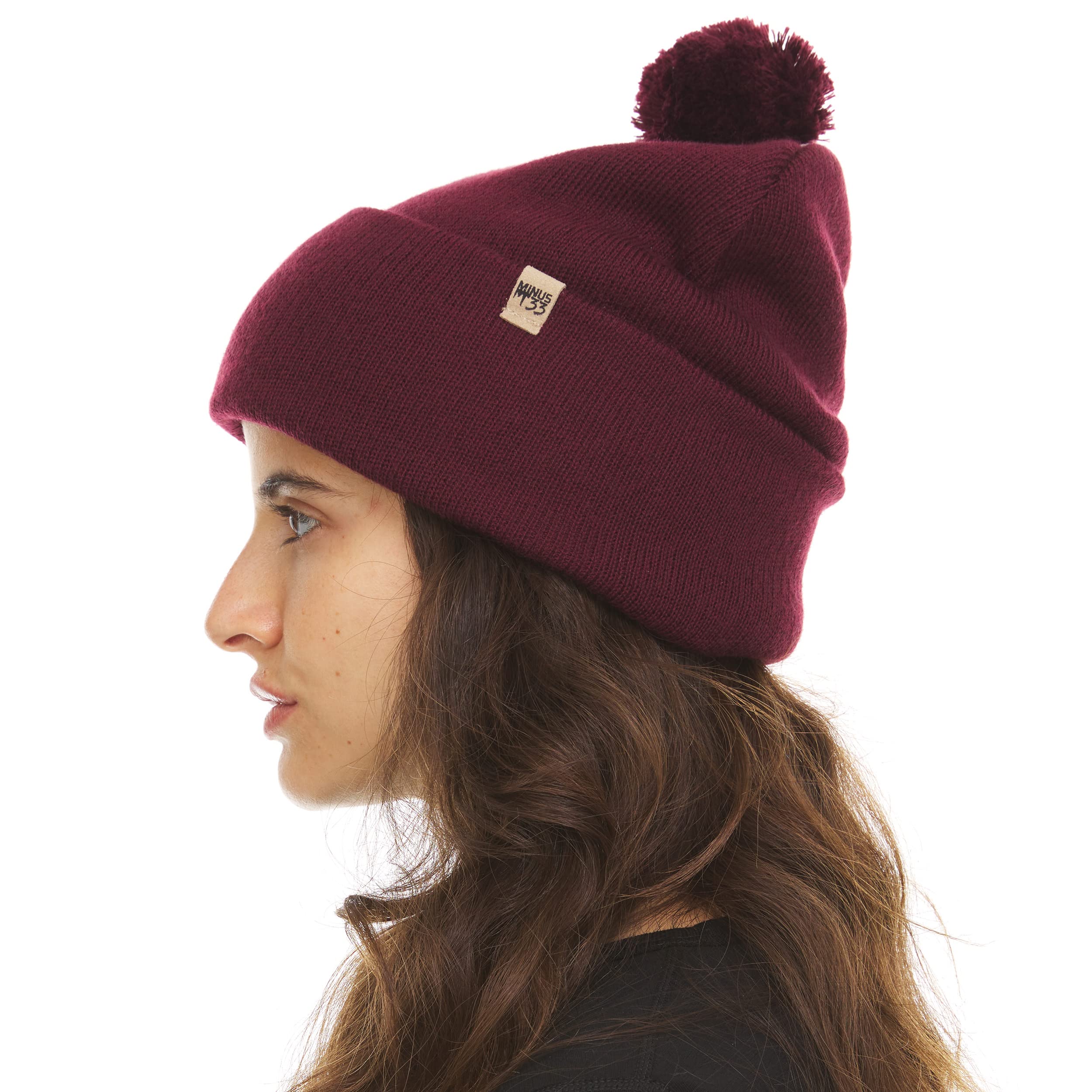 Minus33 burgundy pom beanie ready for skiing and winter outings