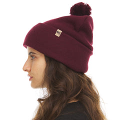 Minus33 burgundy pom beanie ready for skiing and winter outings