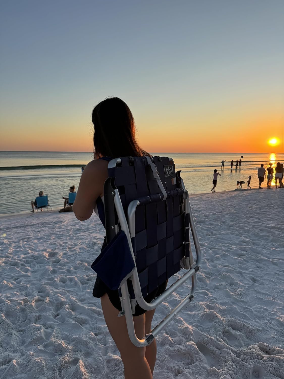 Mountain Summit Gear beach chair unfolded for comfortable seaside lounging.