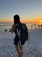 Mountain Summit Gear beach chair unfolded for comfortable seaside lounging.