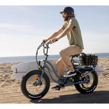Moved By Bikes ebike surf rack on the front frame with foam padding protecting boards.