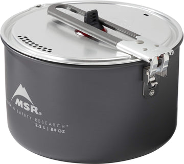 MSR aluminum strainer lid in action for draining and serving camp meals.