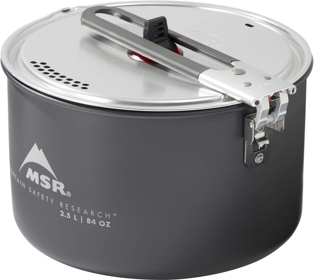 MSR aluminum strainer lid in action for draining and serving camp meals.