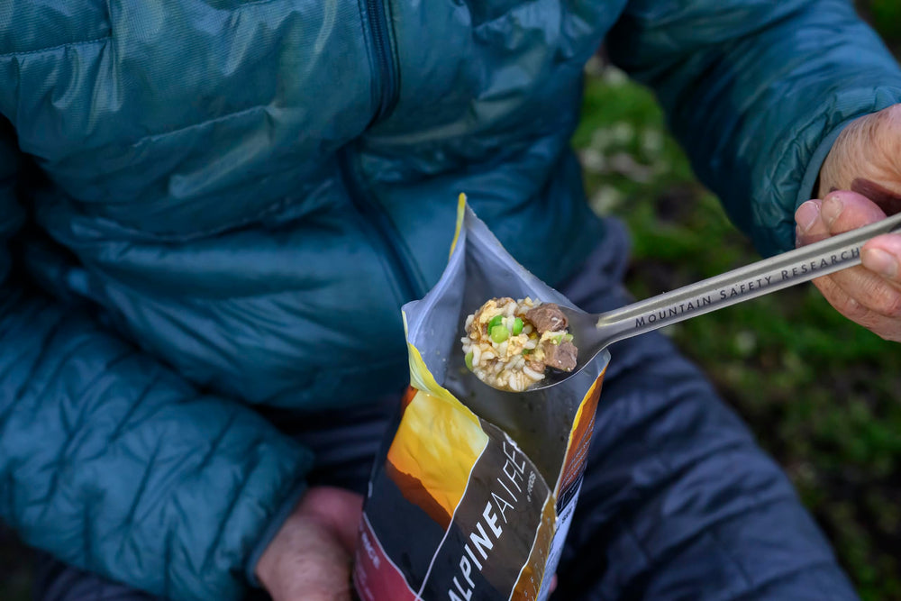 MSR Titan spoon in use with a camping meal for a smooth scoop