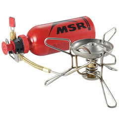 MSR WhisperLite Compact setup with fuel pump and windscreen ready for field use.