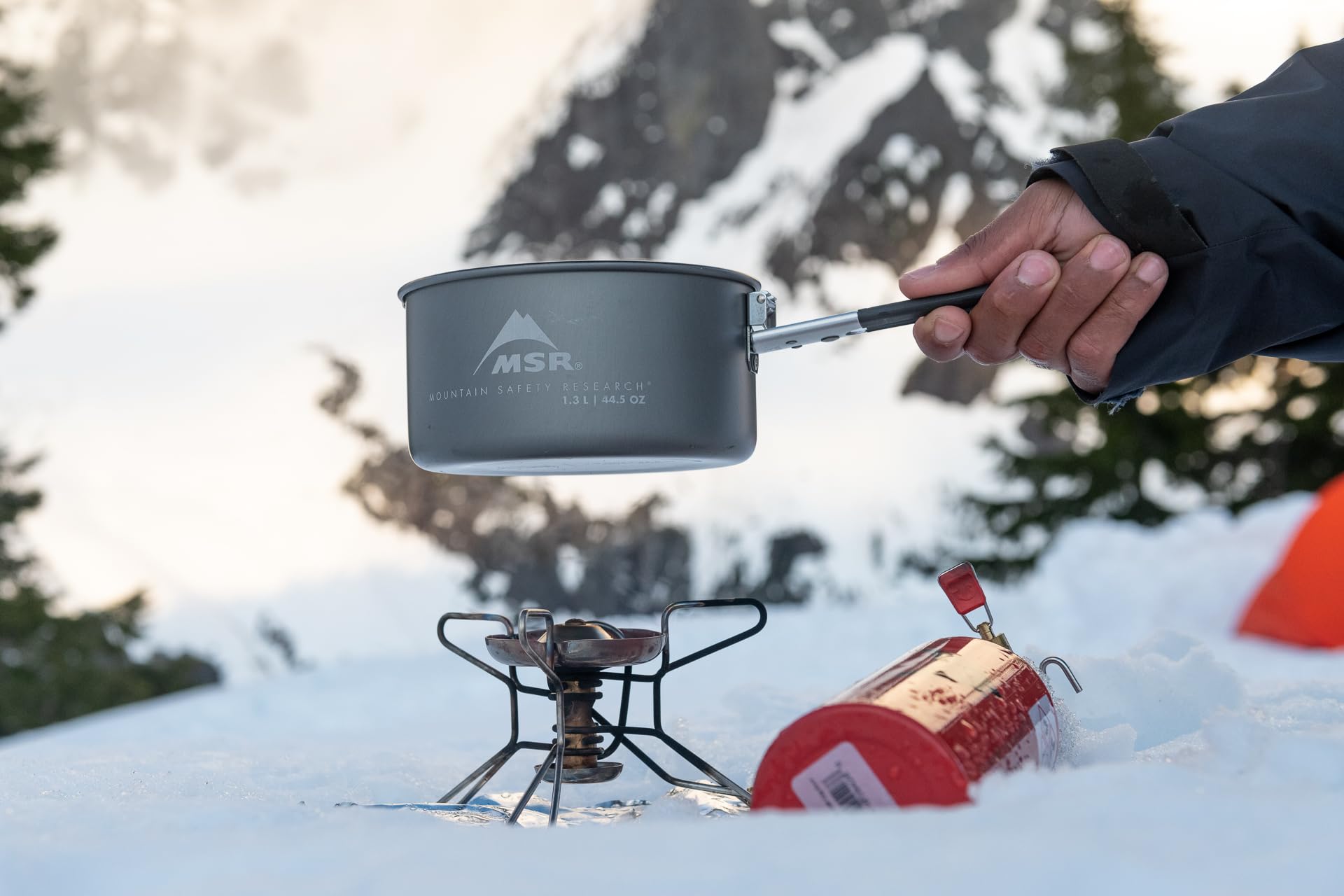 MSR WhisperLite Compact stove setup ready on a rocky campsite