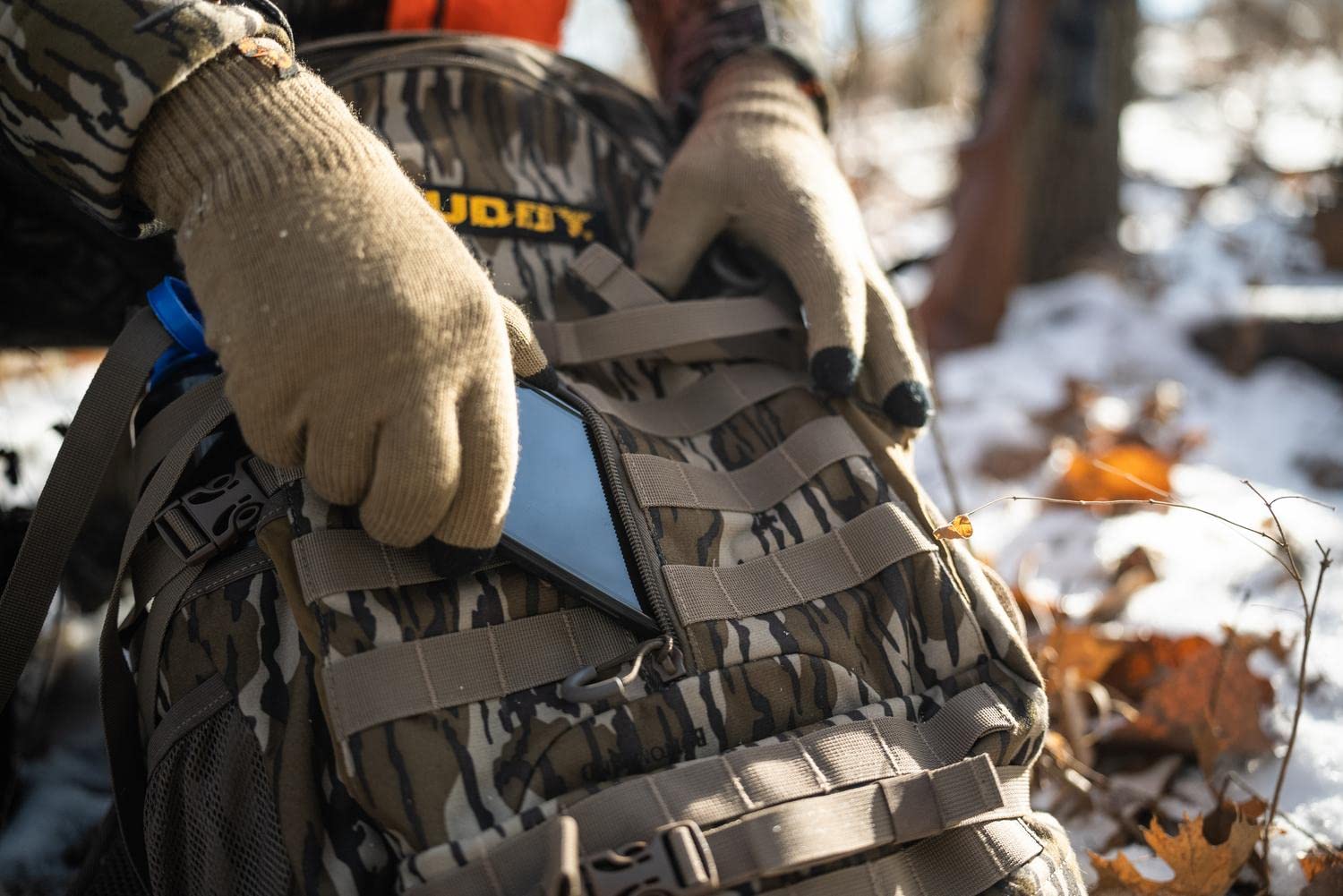 MUDDY Outdoors Pro 1300 backpack in Mossy Oak Bottomland camo for rugged terrain adventures