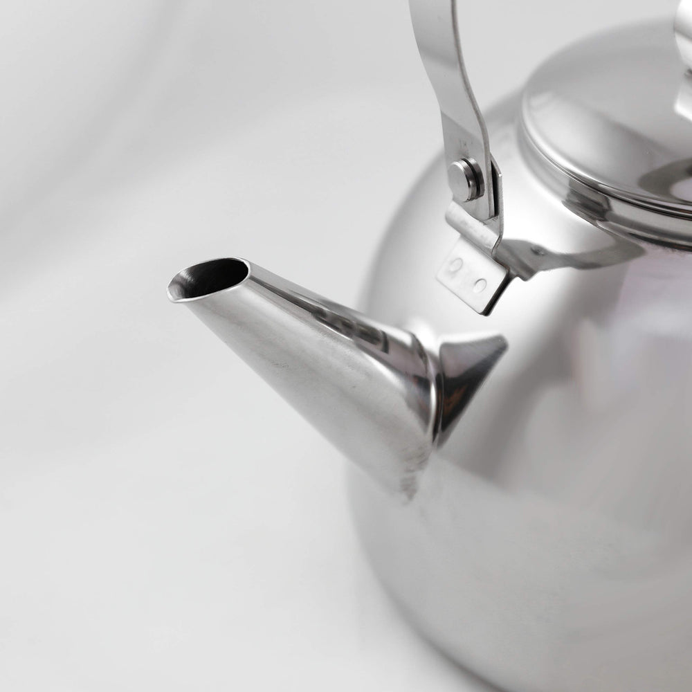 Muurikka camping kettle shaped handle hanging over campfire