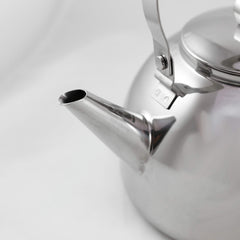 Muurikka camping kettle shaped handle hanging over campfire