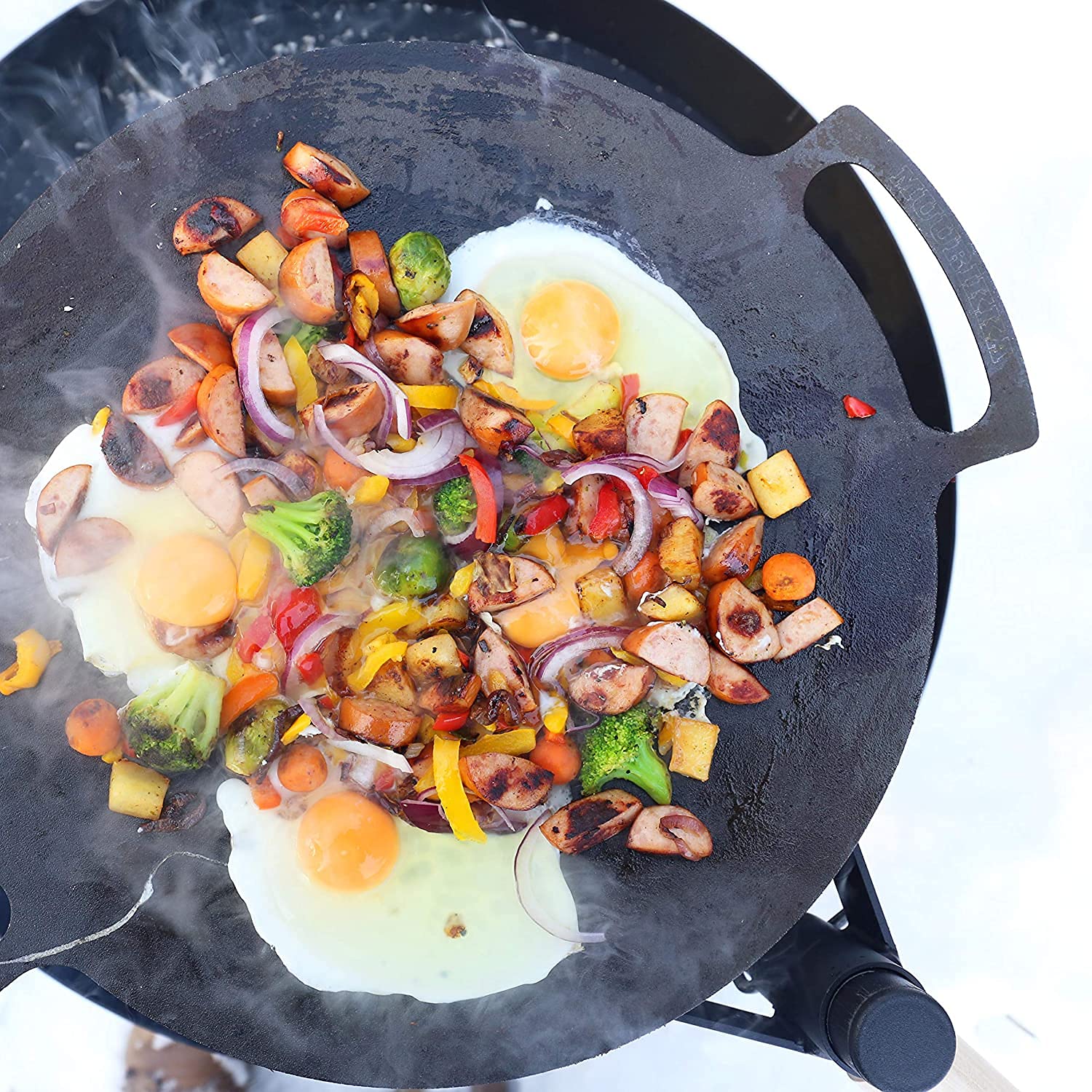 MUURIKKA griddle pan open-fire-cooking delivers smoky flavor and even heating outdoors.
