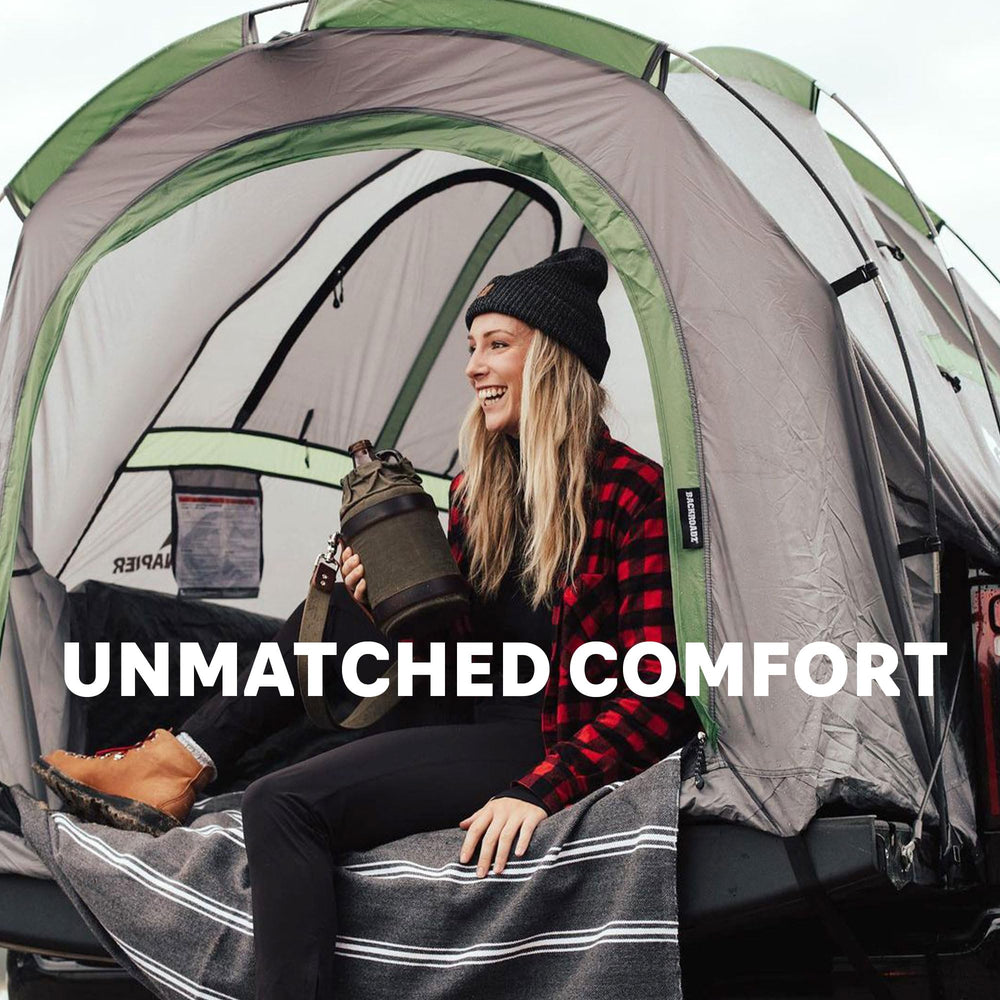 Napier Backroadz truck tent interior shows spacious two-person sleeping area in a truck bed.